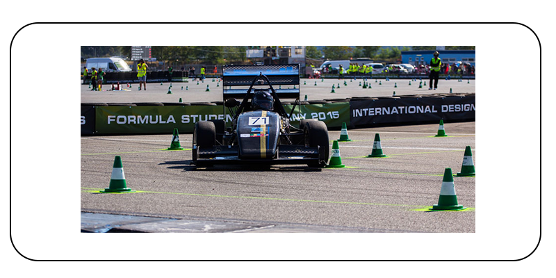 Image of a black formula one racing car on a racetrack