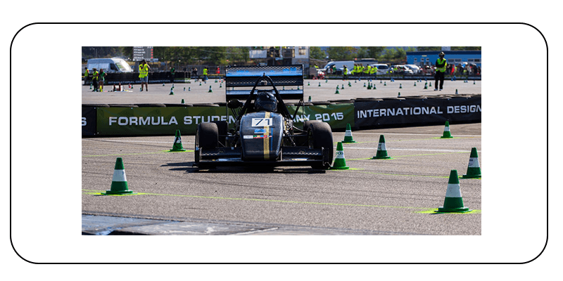 Image of a black formula one racing car on a racetrack