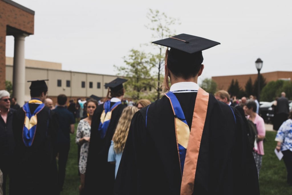 graduate wearing a robe and cap